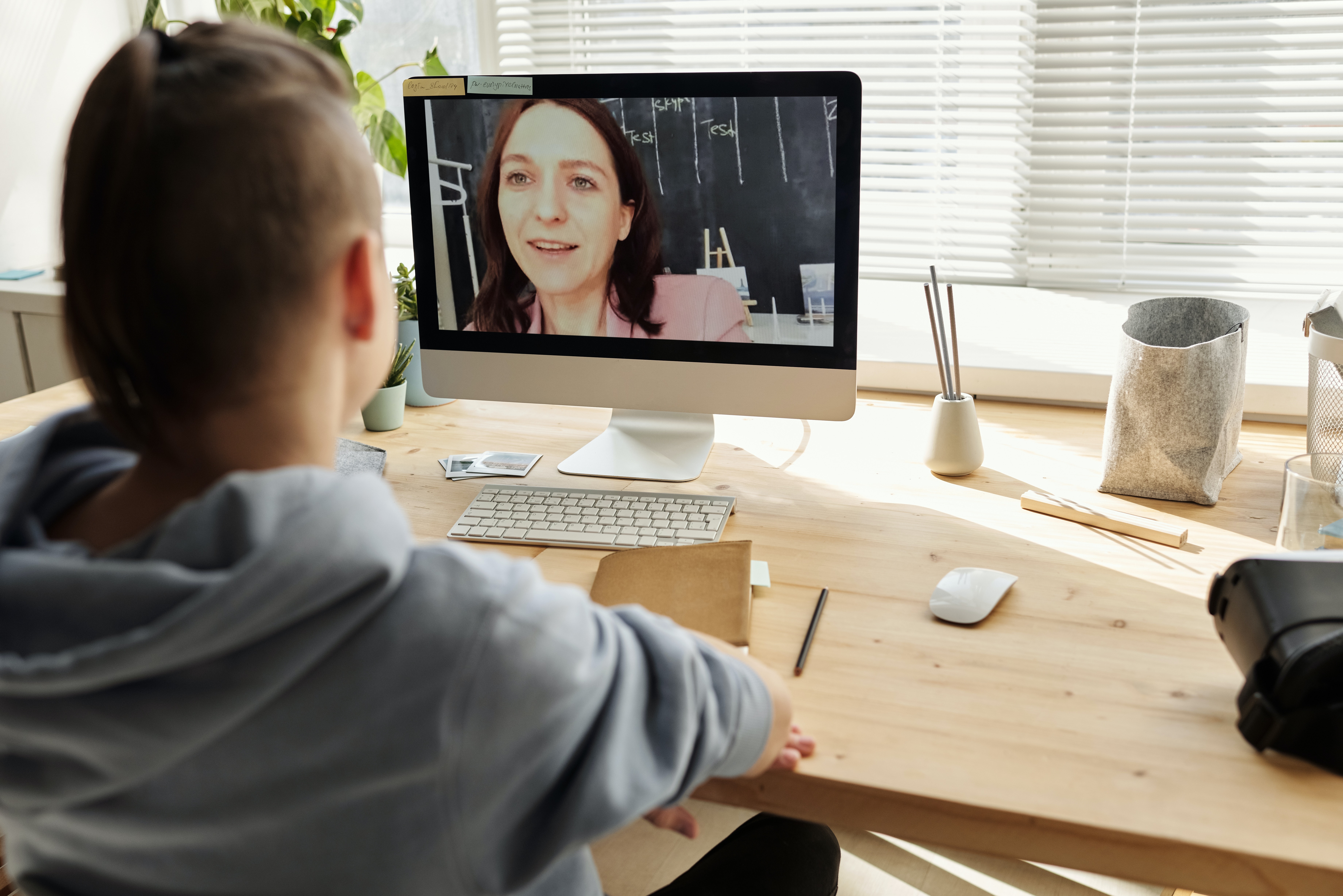 boy-in-gray-hoodie-looking-at-imac-4144530